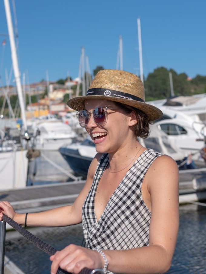 a person standing on a dock next to a body of water
