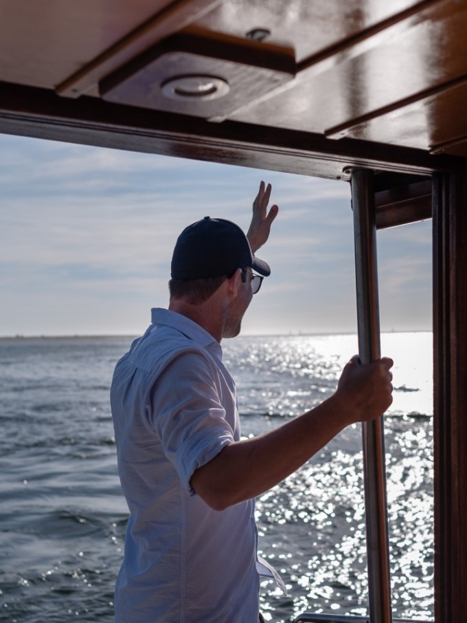 a man standing next to a body of water