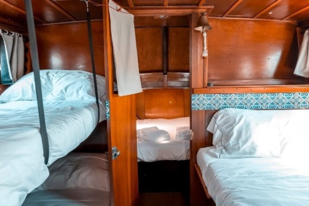 a bedroom with a bed and desk in a room