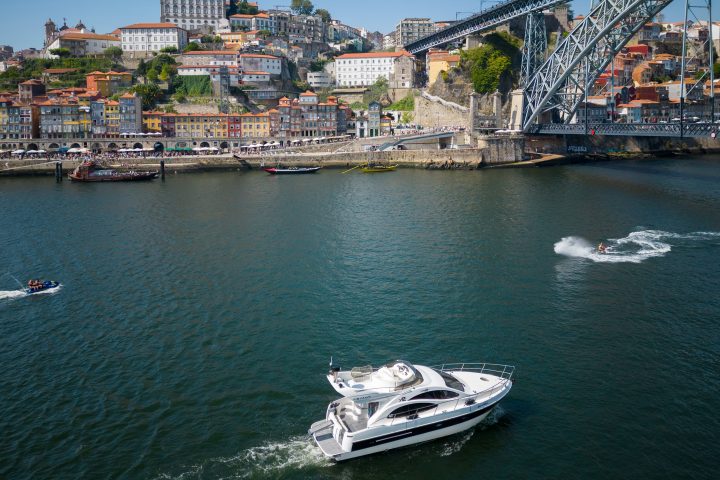 a boat traveling across a bridge over a body of water
