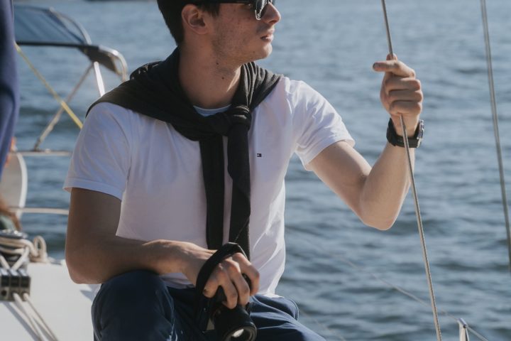 a man standing next to a body of water