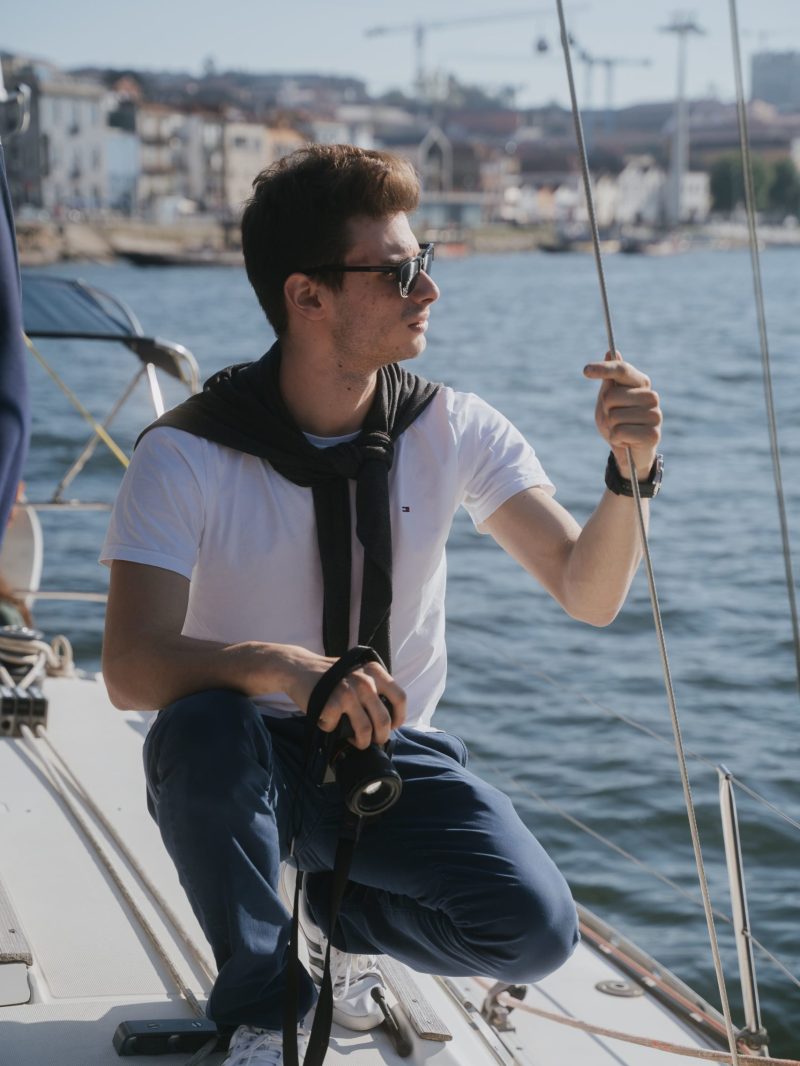 a man standing next to a body of water