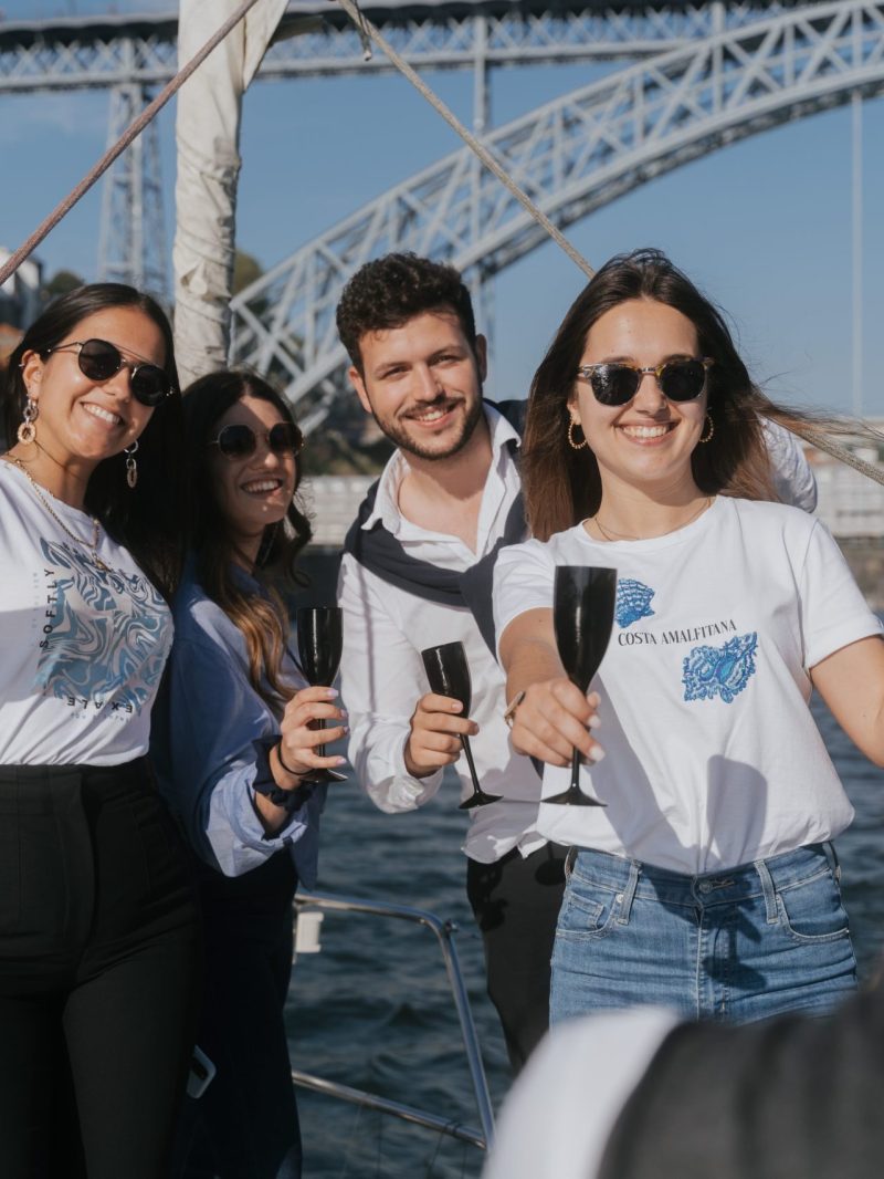 a group of people standing on a bridge over a body of water