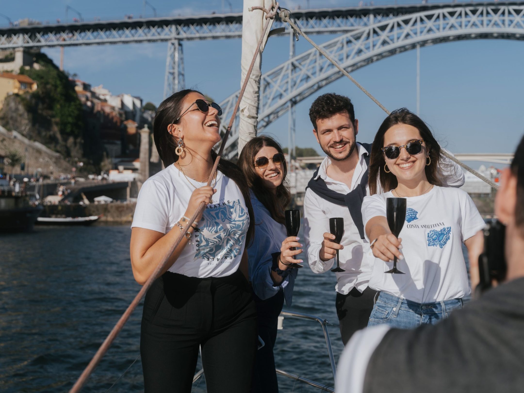 a group of people standing on a bridge over a body of water