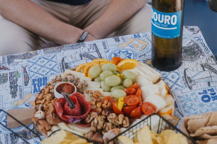 a person sitting at a table with food and a bottle