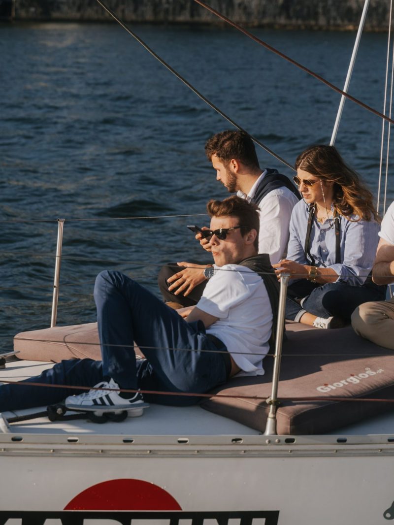 a group of people sitting in a boat on a body of water