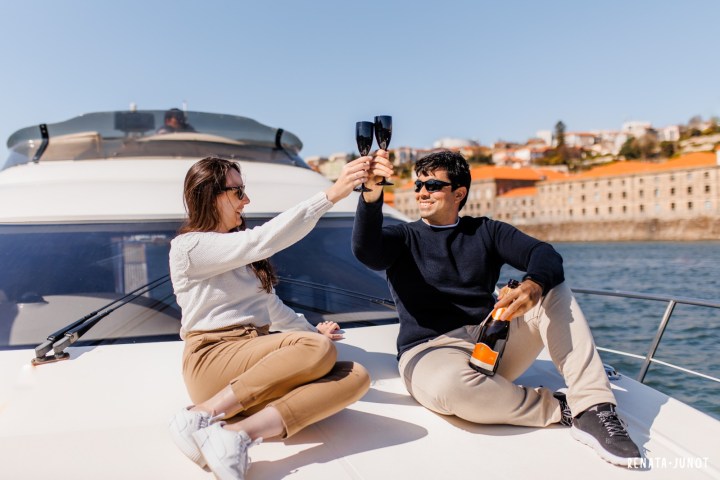 a man and a woman sitting on a boat rio douro sailing 360