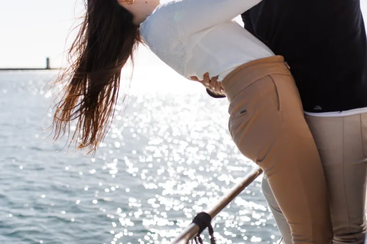 a person standing next to a body of water