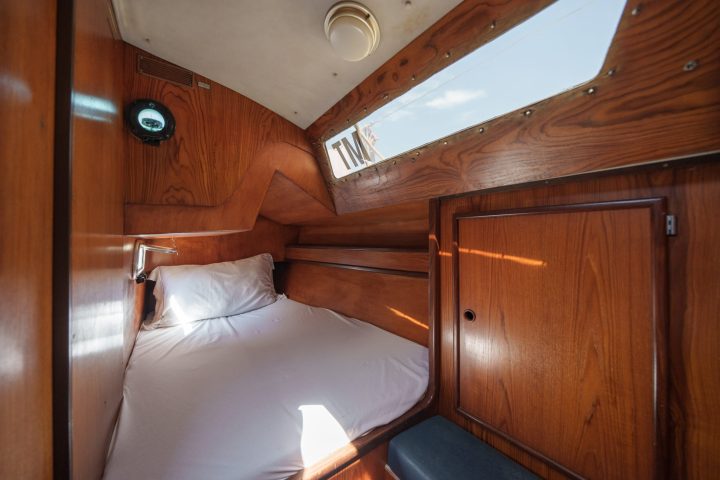 a bedroom with a bed and a wooden cabinet