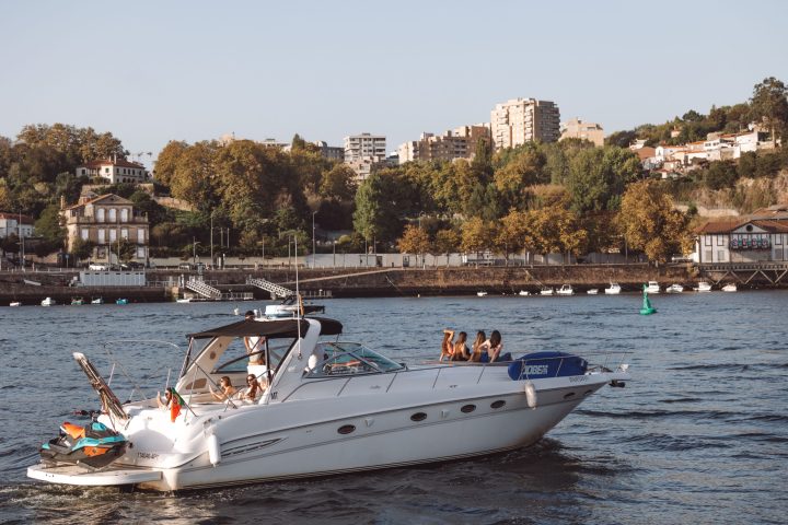 a small boat in a body of water with a city in the background