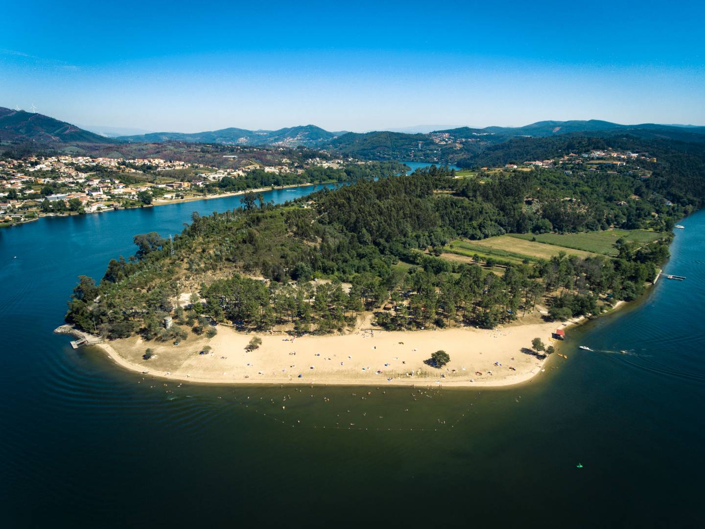 a large body of water with a mountain in the background