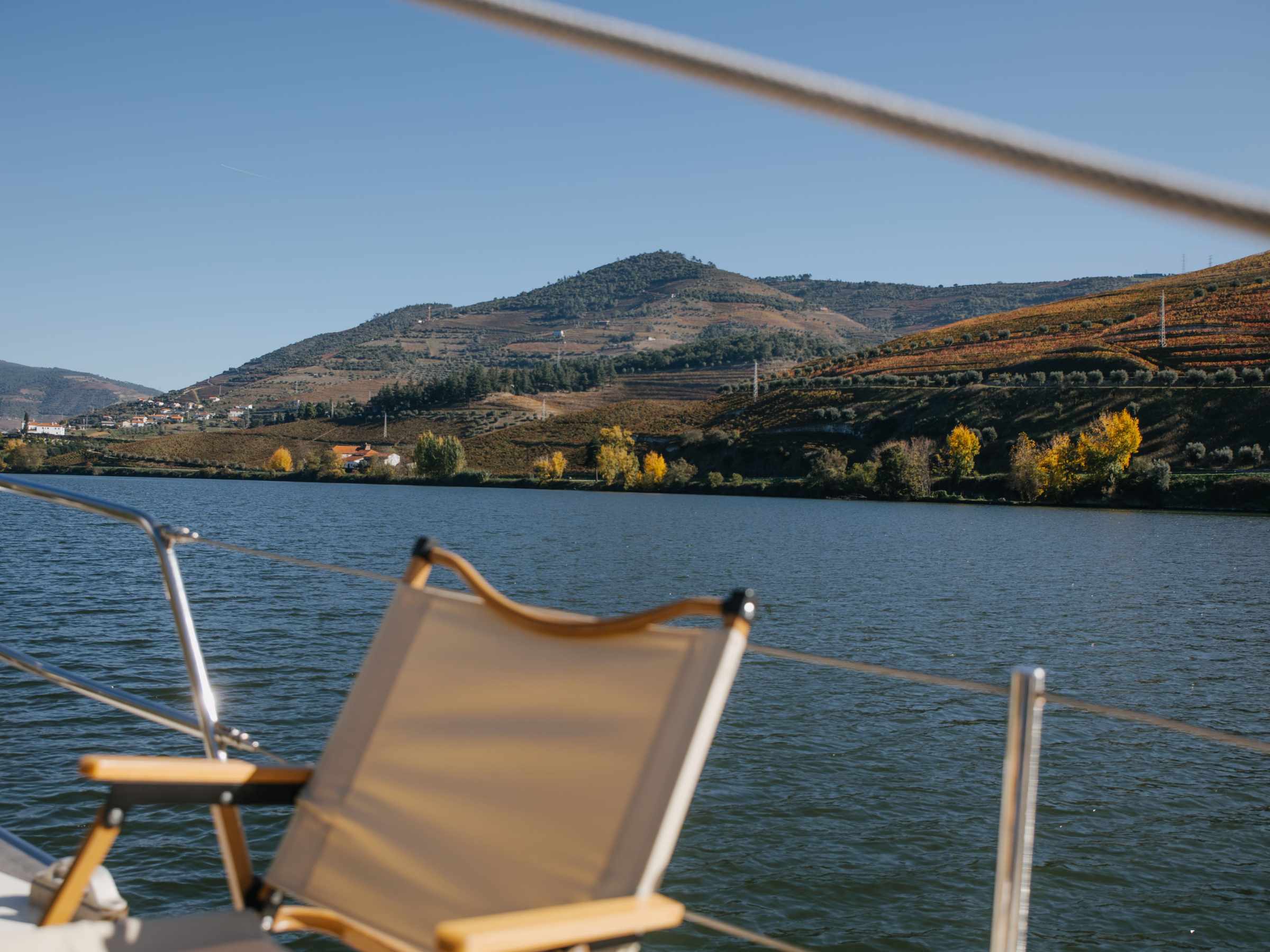 a small boat in a body of water with a mountain in the background