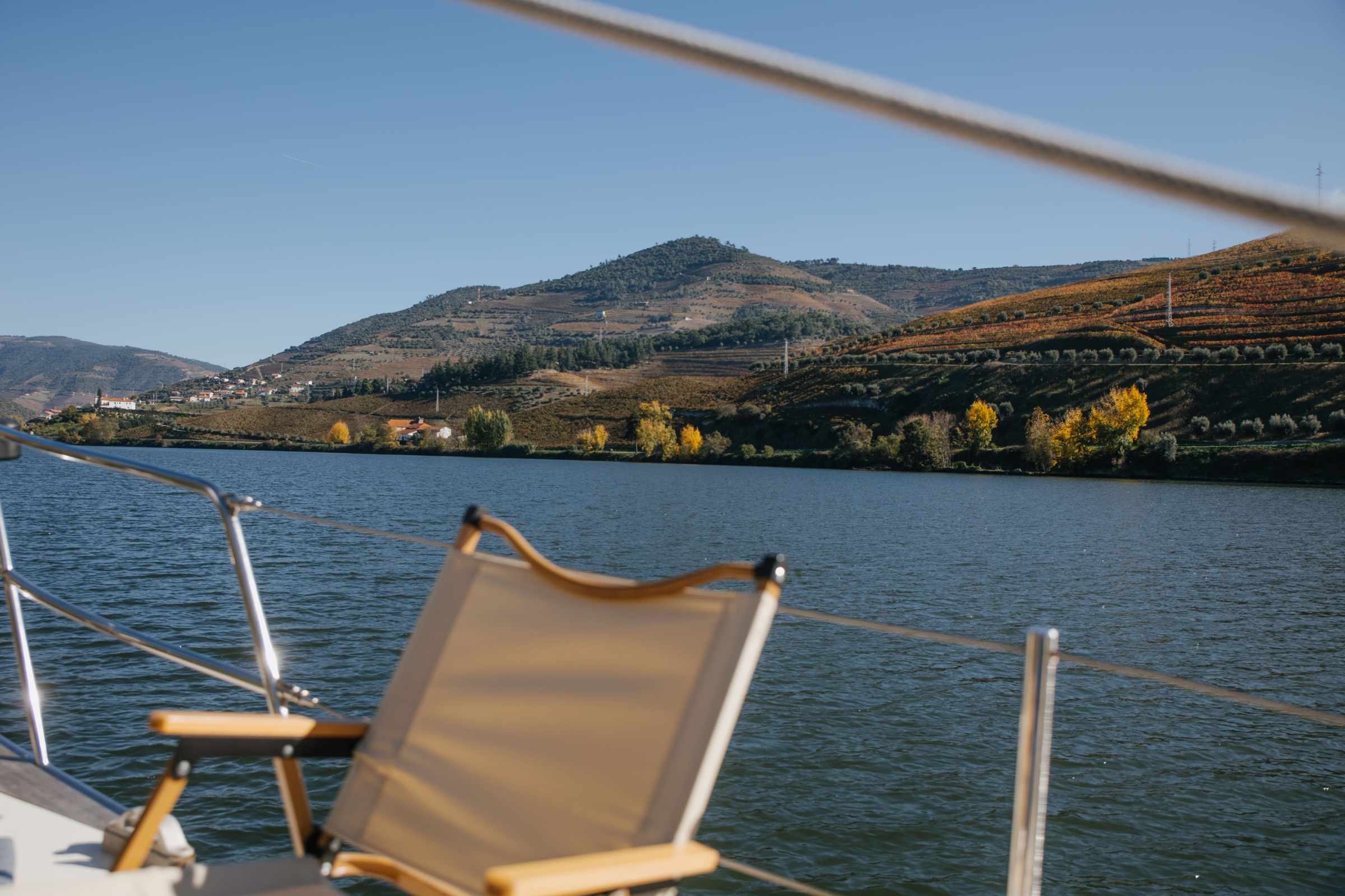 a small boat in a body of water with a mountain in the background