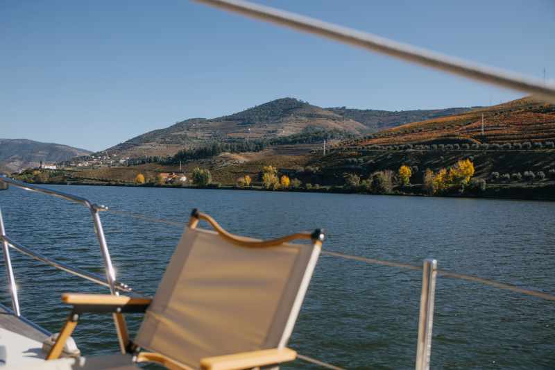 a small boat in a body of water with a mountain in the background