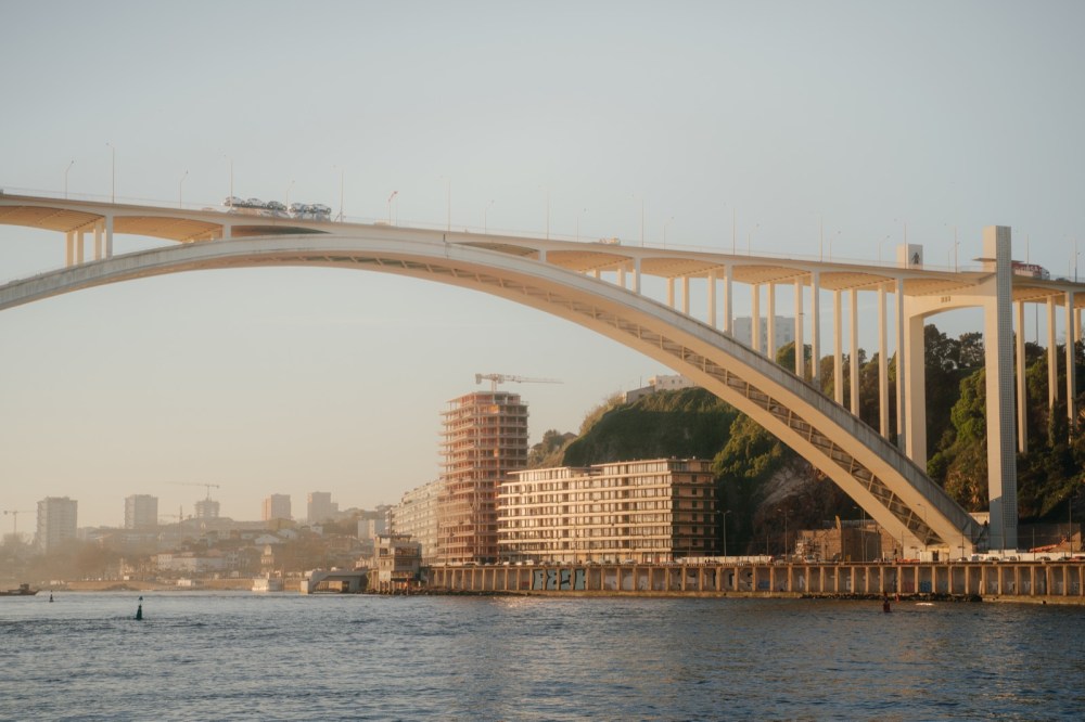 The Arrábida Bridge, with its great white arch over the Douro River, in the late afternoon